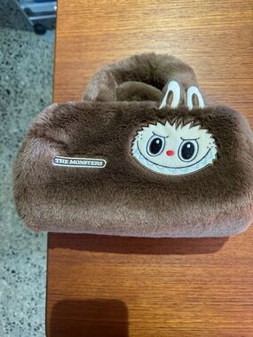 The Monsters fuzzy brown bag